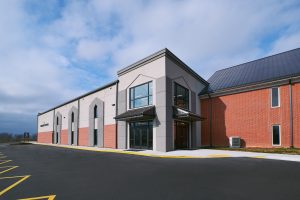 building exterior with brick and grey stucco