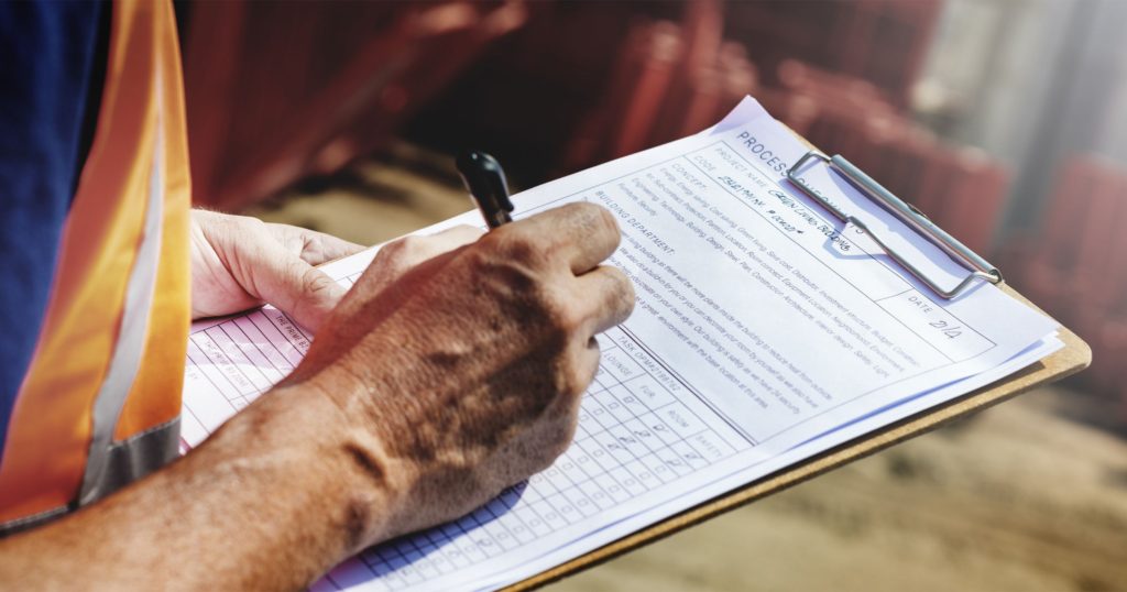 hand writing on a notepad regarding Building Codes and Commercial Construction