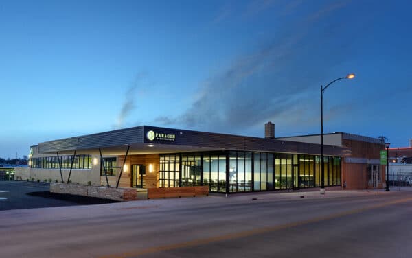 Exterior shot of Paragon Architecture at night with the light on