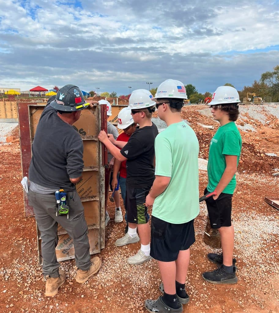 workers showing students a construction site