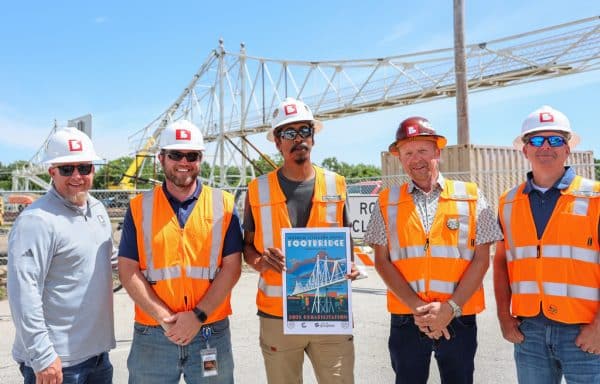 branco employees standing in front of footbridge construction