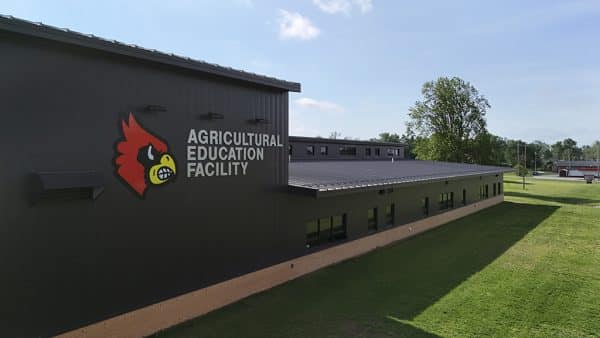 Miller high school ag facility - daytime exterior of the building with the agricultural education facility signage and cardinal image